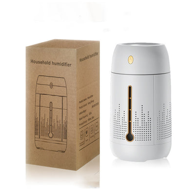 White cylindrical household humidifier with a visible water level indicator, next to its brown cardboard packaging. - Image 7