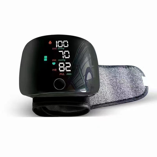 Black wrist sphygmomanometer with a digital display showing blood pressure and pulse readings, and a gray wrist cuff. - Image 10