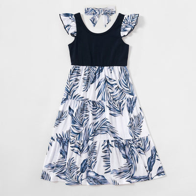 Young boy wearing a white short-sleeve t-shirt with blue tropical leaf print and a black chest pocket. - Image 21