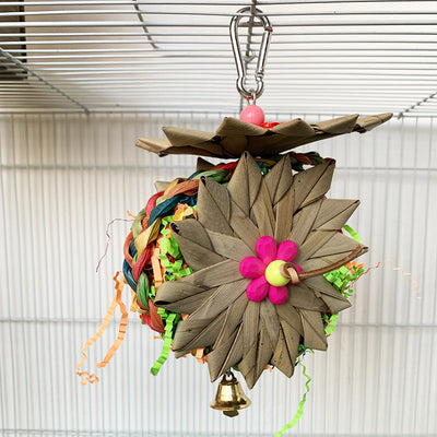 Colorful parrot chew toy made from natural fibers, featuring a woven ball, leaf-like accents, a bell, and a carabiner clip. - Image 4