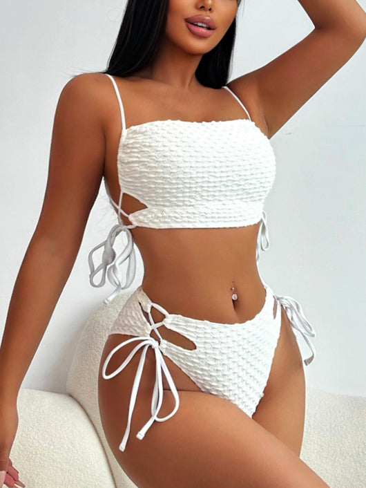 Creamy-white textured two-piece swimsuit with a bandeau top and high-waisted bottoms featuring side ties and cut-outs. - Image 8