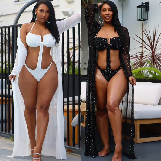 Woman in black mesh see-through long sleeve swimsuit cape over a matching cutout bandeau swimsuit with hot drilling.