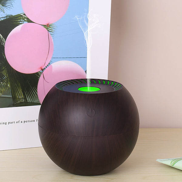Dark wood grain spherical USB humidifier with a green light and mist emitting from the top, featuring a power button icon. - Image 4