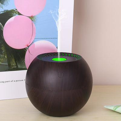 Dark wood grain spherical USB humidifier with a green light and mist emitting from the top, featuring a power button icon. - Image 4
