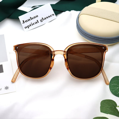Cream and grey round zippered glasses case with a cream strap, shown from front and back views.