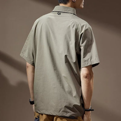 Men's khaki short-sleeve polo shirt with a lapel collar, three buttons, and a large flap chest pocket with a D-ring. - Image 3