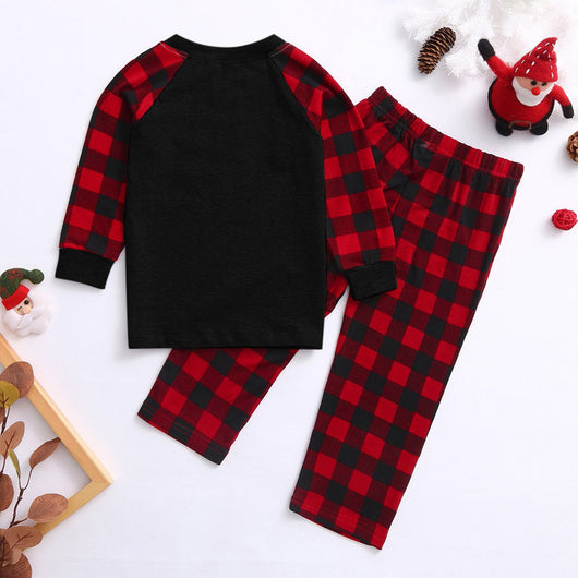 Kids' Christmas pajamas with a black long-sleeve top featuring a cartoon bear in a plaid scarf and ice skates, paired with red and black plaid pants. - Image 2