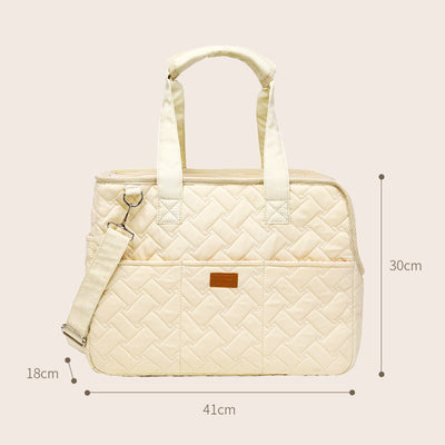 Cream quilted portable pet carrier with top handles, detachable shoulder strap, front pocket, and ventilation mesh. - Image 7