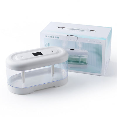 Dark green and clear oval USB humidifier with two mist outlets, shown next to its white product box. - Image 10