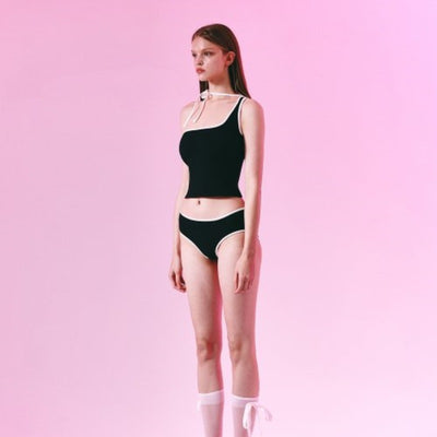 Women's light purple one-shoulder swimsuit with dark red contrast trim, lying on a striped blanket on green grass. - Image 3