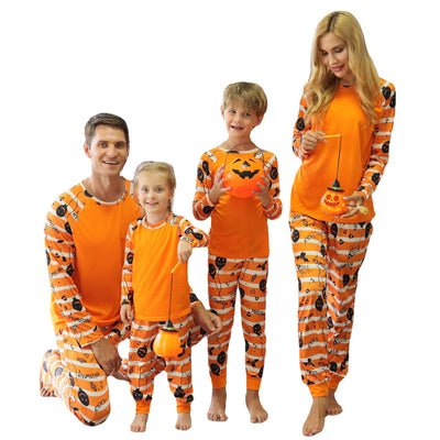 Family of four wearing matching orange and white striped Halloween pajamas with pumpkin and bat prints. - Image 12