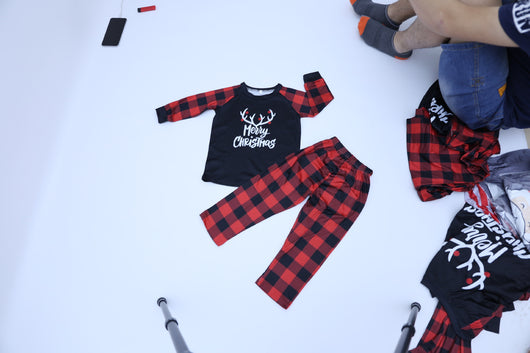 Black and red buffalo plaid pajama set with 'Merry Christmas' and reindeer antlers on the long-sleeved top. - Image 9