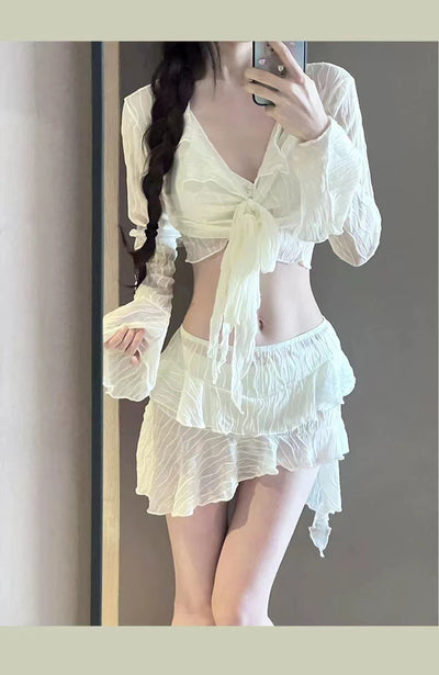 White four-piece bikini swimsuit set for women, featuring a long-sleeve tie-front top and tiered ruffle skirt. - Image 4