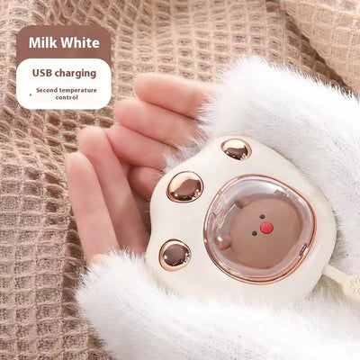 Dark green paw-shaped hand warmer and power bank with a cute bear design, held in a hand with white faux fur gloves. - Image 9
