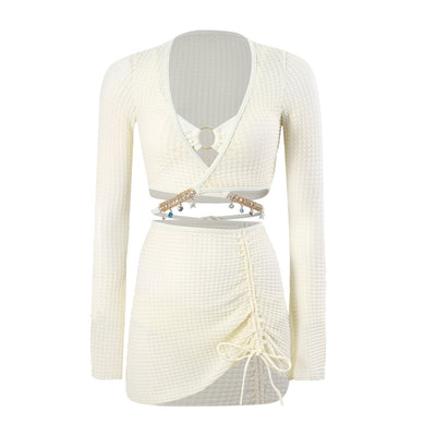 White three-piece bikini swimsuit set with a long-sleeve crop top, bikini top with gold ring, and ruched mini skirt. - Image 3