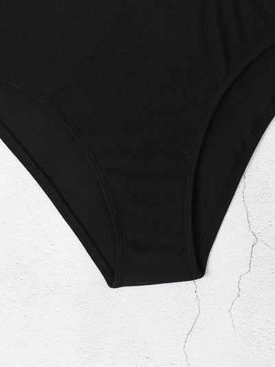 Black one-shoulder one-piece swimsuit with side cut-outs and gold chain-link detailing on strap and waist. - Image 8