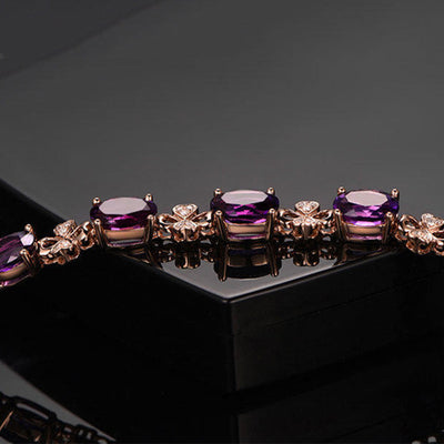 Rose gold necklace with a teardrop purple gemstone pendant and matching dangle earrings. - Image 17