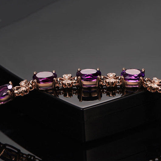 Rose gold necklace with a teardrop purple gemstone pendant and matching dangle earrings. - Image 17