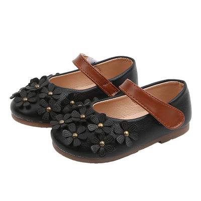 Black Mary Jane shoes for girls with 3D flower appliques on the toe and a brown hook-and-loop strap. - Image 9