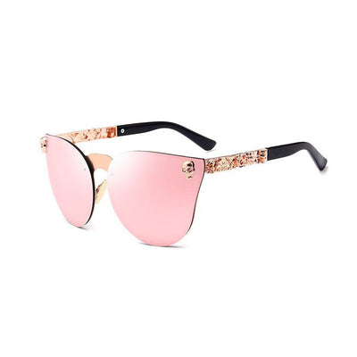 Pink mirrored cat-eye sunglasses with gold-toned frames, skull, and floral embellishments on the temples. - Image 9