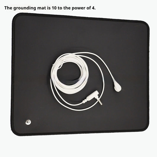 Person standing barefoot on a black rectangular grounding mat with a connected wire, used for earthing. - Image 4
