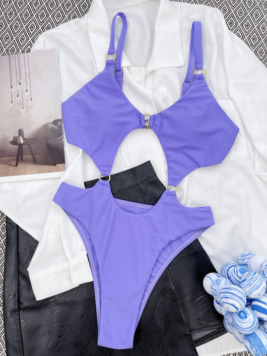 Purple one-piece swimsuit with front cut-outs and gold-tone O-ring details, modeled by a woman. - Image 4