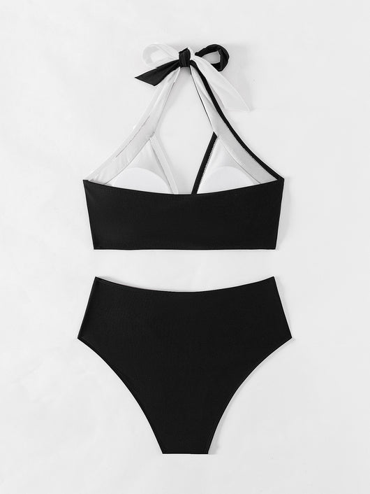 Black and white color-block halter bikini with high-waisted bottoms, modeled by a woman holding a straw hat. - Image 27