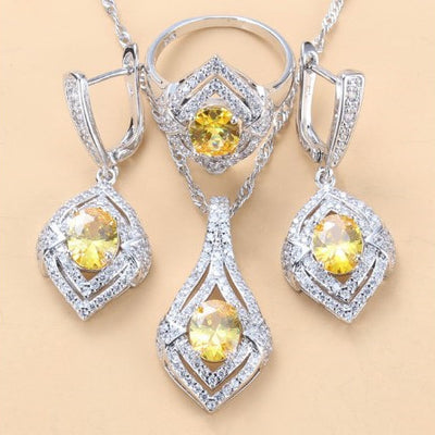 Silver-toned three-piece jewelry set with clear oval and round gems, including a necklace, dangle earrings, and a ring. - Image 12