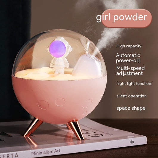Space gray spaceman humidifier with a clear dome, glowing purple astronaut figurine, and warm yellow night light. - Image 4