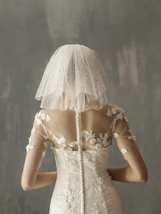 White multi-layer short bridal veil with gold star embellishments, worn by a model in a white lace wedding dress. - Image 12