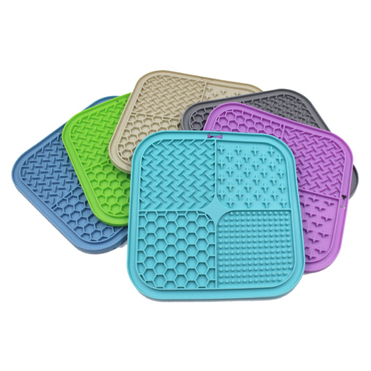Gray silicone pet licking pad with four textured sections, designed for slow feeding and anti-choking.
