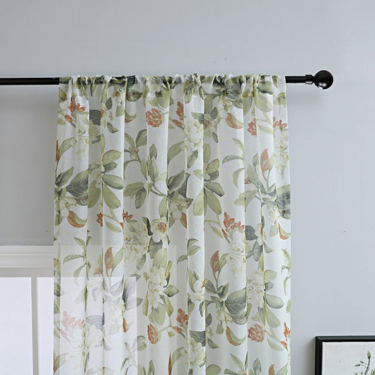 Dark gray semi-sheer curtains with a white and green floral pattern, hung on a black rod in a living room. - Image 3
