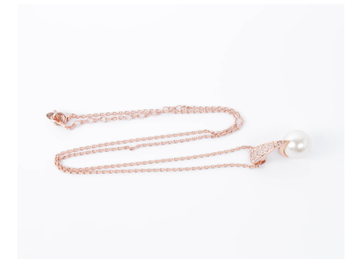 Rose gold-toned necklace and drop earrings set with white spherical pearls and clear rhinestone accents. - Image 11