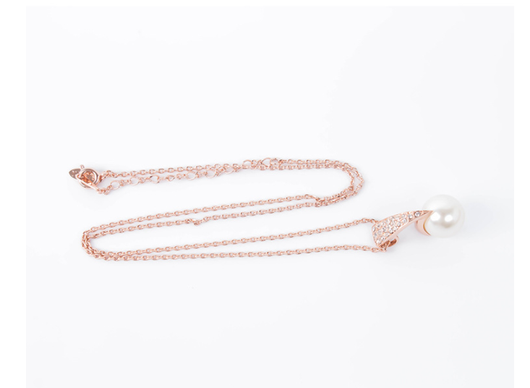 Rose gold-toned necklace and drop earrings set with white spherical pearls and clear rhinestone accents. - Image 11