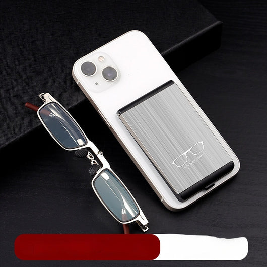 Foldable blue light blocking glasses with silver frames in a black case, shown on a smartphone. - Image 2