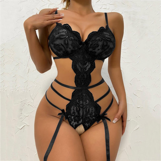White lace transparent bodysuit featuring a scalloped bra, intricate floral lace, and strappy garter details with bows.