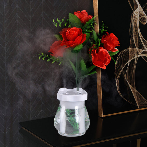 Creative desktop humidifier with artificial red roses, clear base, pink top, and color-changing LED light mist.