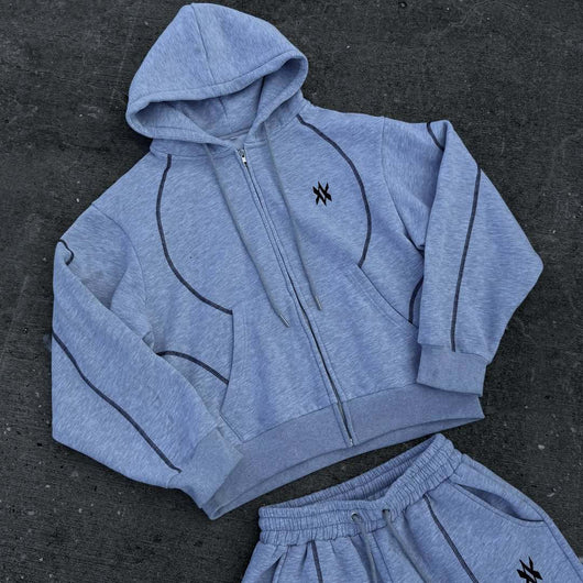 Light gray hooded tracksuit with dark gray contrast stitching, featuring a full-zip hoodie and matching loose sweatpants. - Image 6