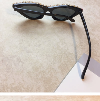 Two pairs of cat-eye sunglasses, one black with clear rhinestones and one pink with pink rhinestones, on a light surface. - Image 9
