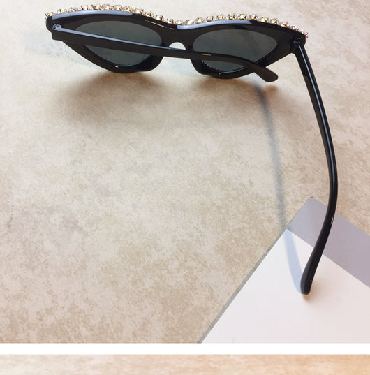 Two pairs of cat-eye sunglasses, one black with clear rhinestones and one pink with pink rhinestones, on a light surface. - Image 9