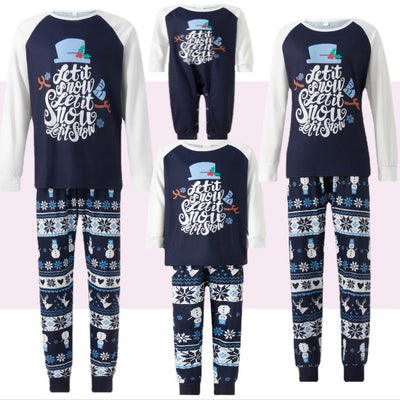 Matching family pajamas with navy blue and white raglan tops featuring a 'Let it Snow' graphic and snowman hat. Bottoms have a festive pattern of snowflakes, sn