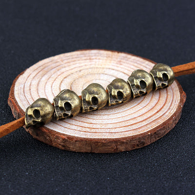 Red velvet rope with six silver-colored skull beads, ideal for DIY hair accessories or crafting projects. - Image 3