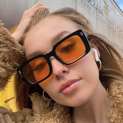 Women's retro hip hop fashion sunglasses with bright black frames, dark gray rectangular lenses, and gold accents.