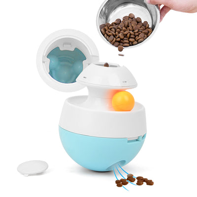 Orange and blue interactive pet food dispenser toy with multiple tiers and white balls, next to its black packaging. - Image 5