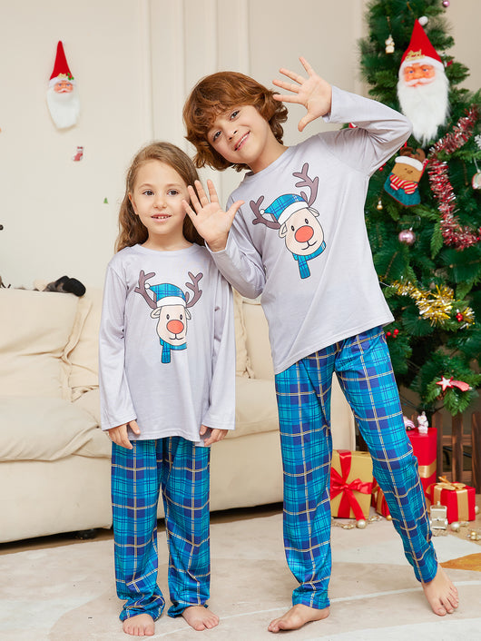 Young girl wearing a grey long-sleeve pajama top with a cartoon reindeer and blue plaid pajama pants. - Image 5