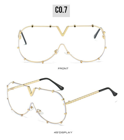 Oversized V-shaped sunglasses with a gold metal frame, white accents, clear lenses, and decorative rivets. - Image 14