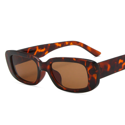 Black rectangular fashion sunglasses with dark lenses, featuring a thick frame and temples, angled on a white background. - Image 4