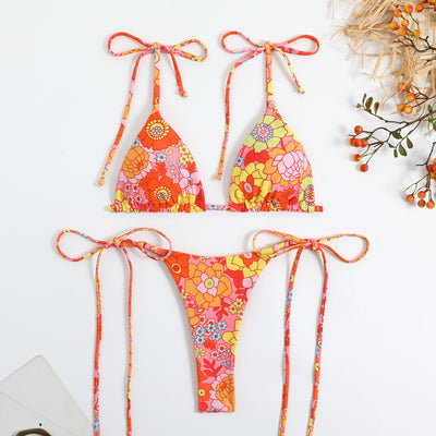Vibrant floral print bikini set with tie-side triangle top and matching bottoms, featuring pink, blue, orange, and purple flowers. - Image 8