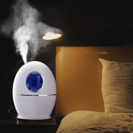White egg-shaped household humidifier with a blue-lit circular opening and silver trim. - Image 10