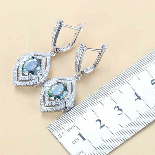 4-piece women's jewelry set with silver-tone necklace, ring, earrings, and bracelet, featuring red oval gemstones surrounded by clear accent stones. - Image 5